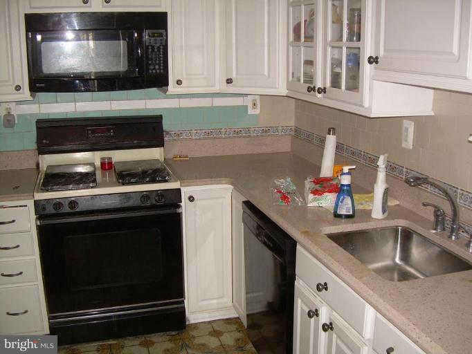78 Rittenhouse Street Northeast Washington, DC 20011 - Photo 3 of 7 a kitchen with stainless steel appliances a stove a sink and a microwave