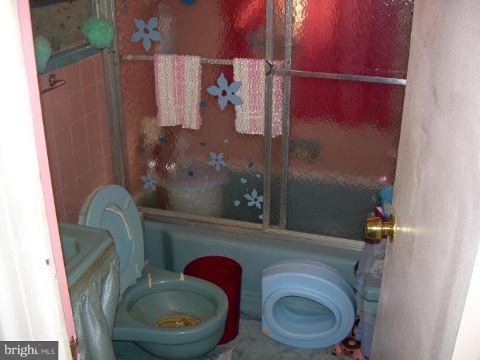 78 Rittenhouse Street Northeast Washington, DC 20011 - Photo 4 of 7 a bathroom with a toilet and a mirror