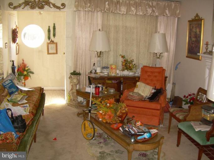 78 Rittenhouse Street Northeast Washington, DC 20011 - Photo 6 of 7 a living room with patio furniture and a chandelier