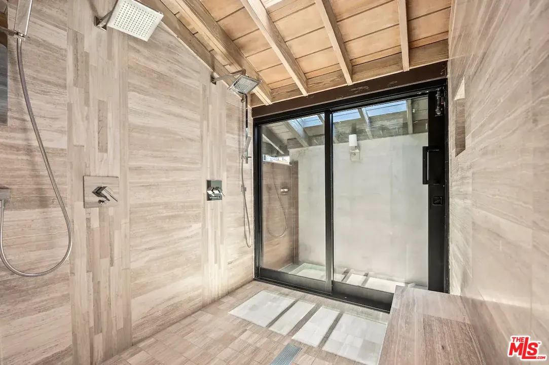 24608 Malibu Road Malibu, CA 90265 - Photo 18 of 30 a view of a hallway with wooden floor and a bathroom