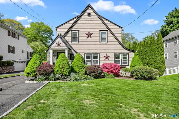 a front view of a house with a garden