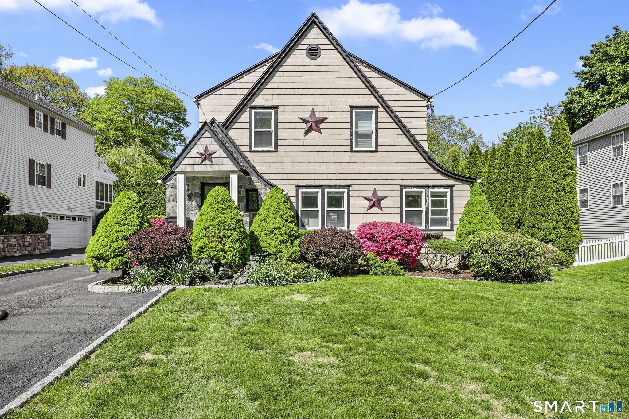 a front view of a house with a garden