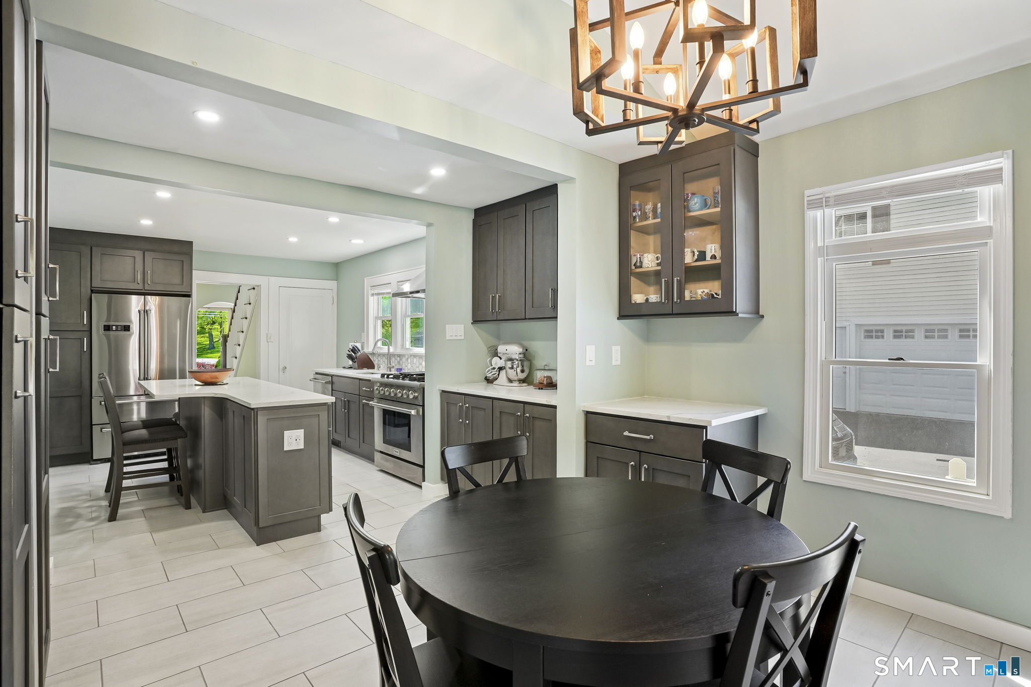 315 Church Hill Road Trumbull, CT 06611 - Photo 17 of 40 a kitchen with kitchen island a dining table chairs stainless steel appliances and cabinets