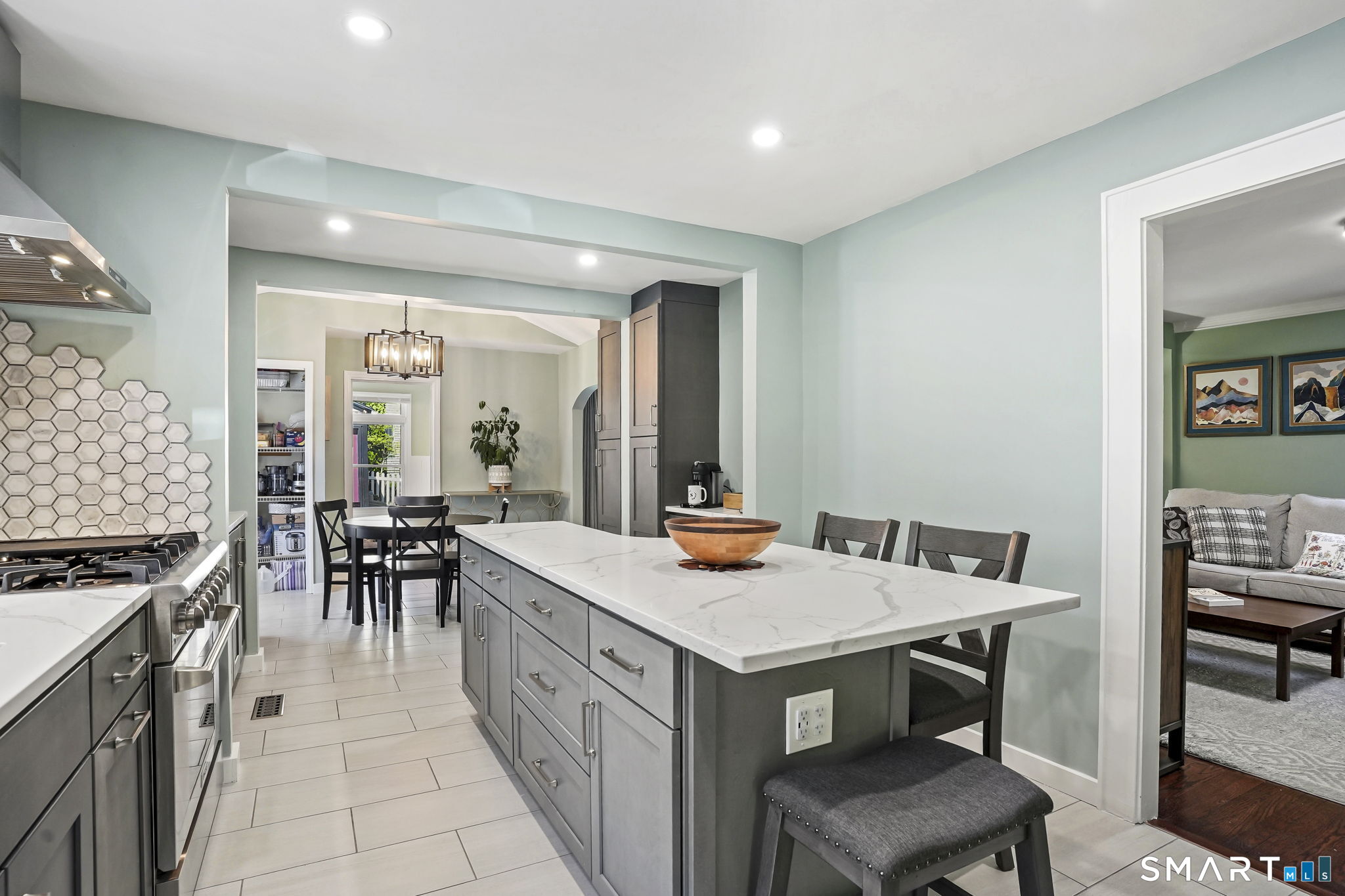 315 Church Hill Road Trumbull, CT 06611 - Photo 19 of 40 a kitchen with a stove a kitchen island a sink and chairs
