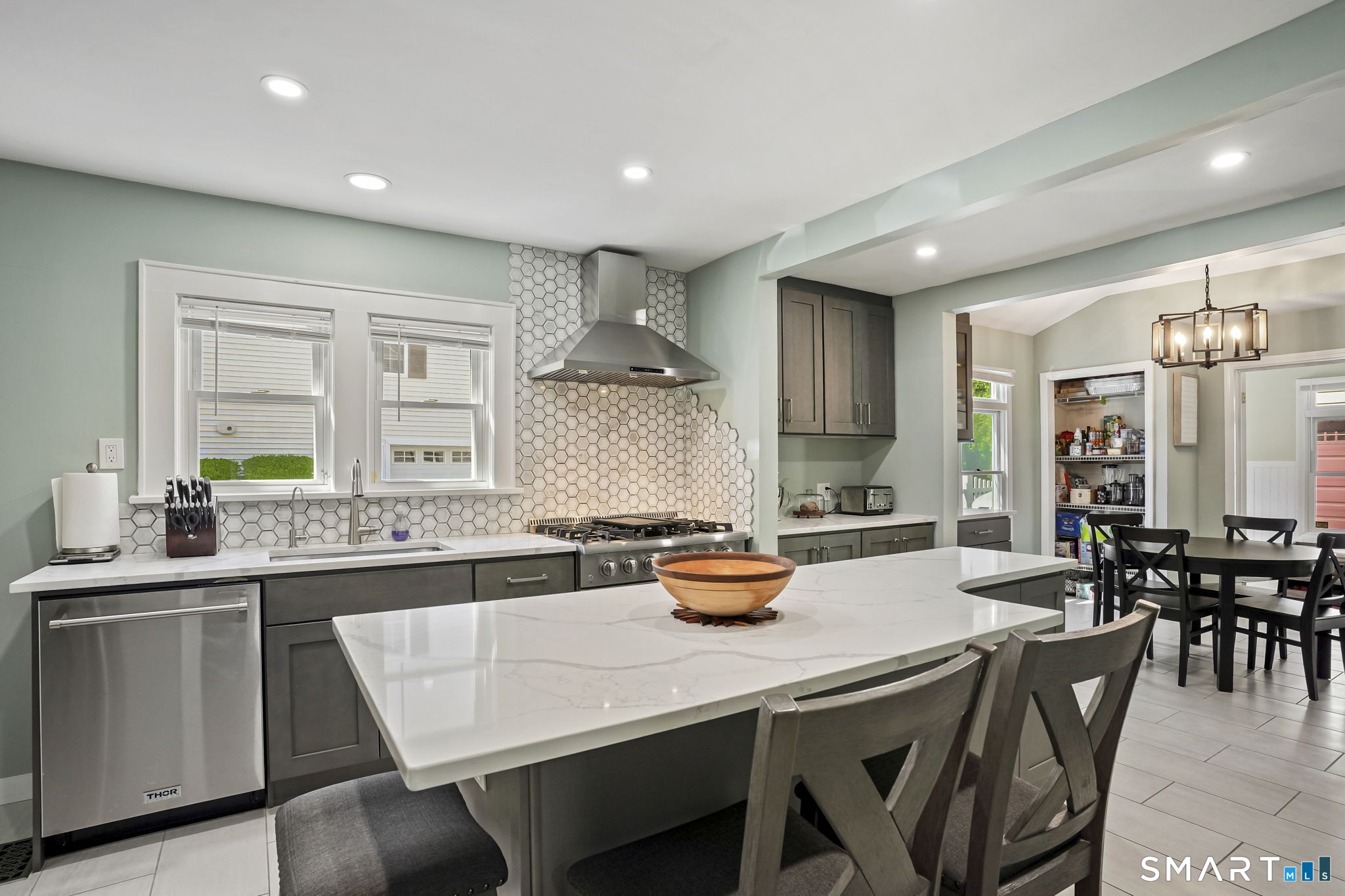 315 Church Hill Road Trumbull, CT 06611 - Photo 21 of 40 a kitchen with a sink a stove a refrigerator and chairs