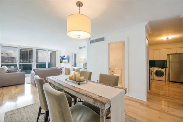 a view of a dining room with furniture wooden floor and chandelier