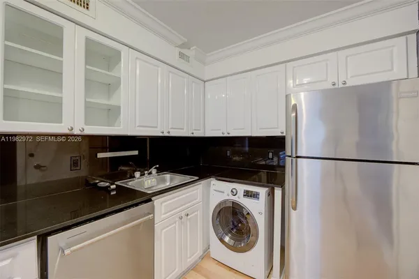 a kitchen with a refrigerator and a stove