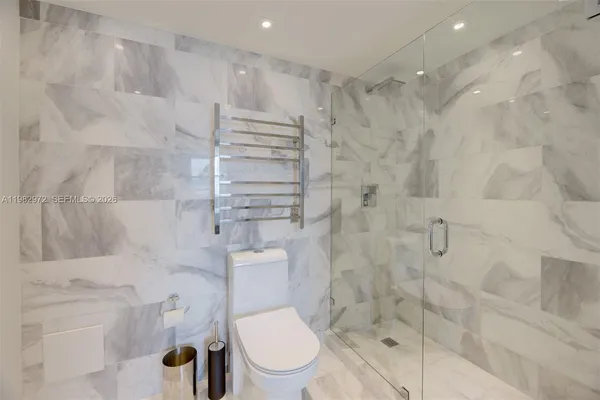 a bathroom with a toilet and a shower