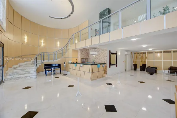 a view of a hallway with dining room and furniture