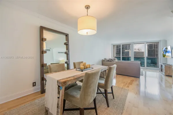 a view of a dining room with furniture and wooden floor