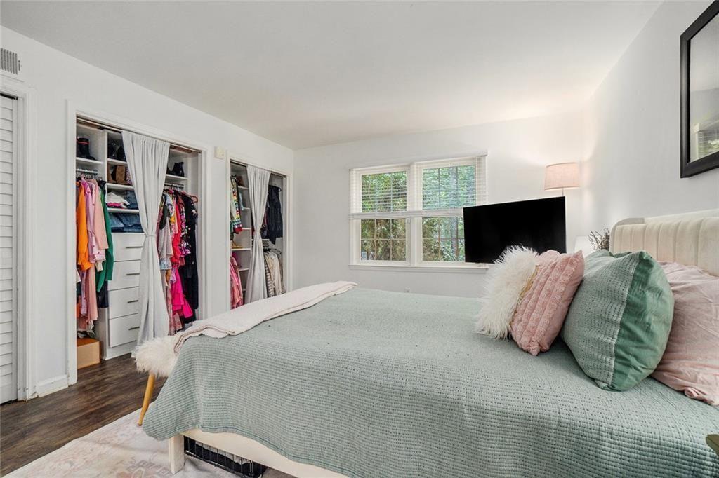 94 Rosaire Place Northwest Atlanta, GA 30327 - Photo 11 of 21 a bedroom with a large bed and a flat tv screen