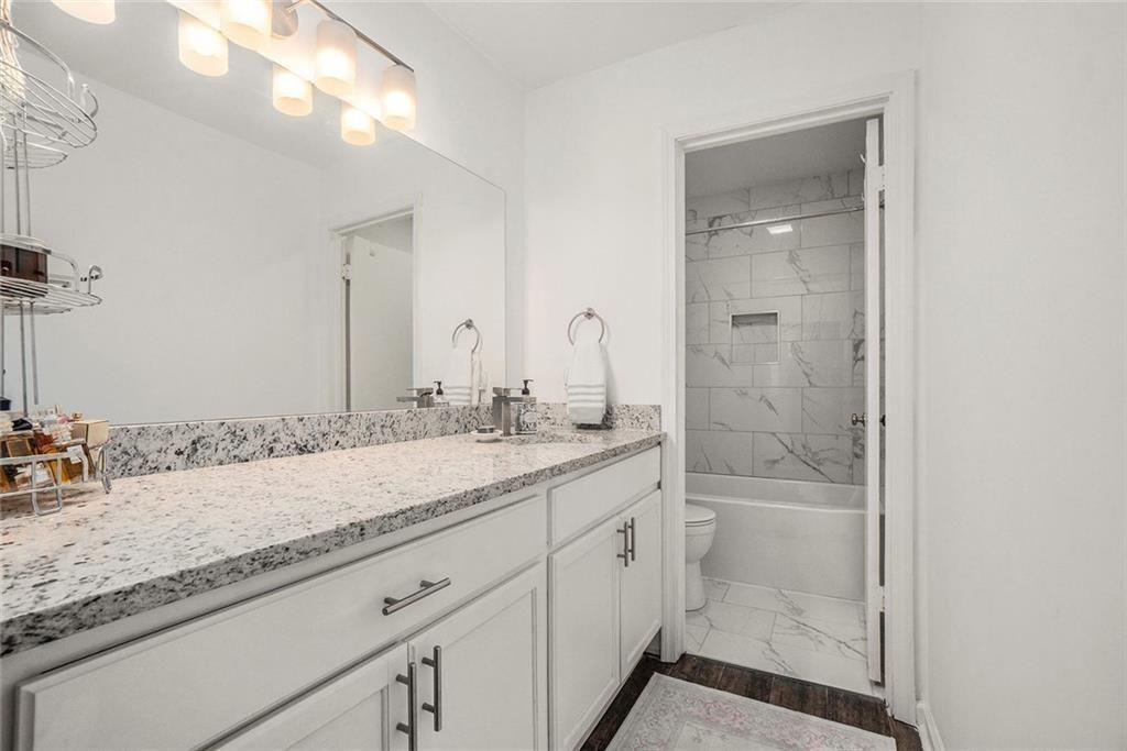 94 Rosaire Place Northwest Atlanta, GA 30327 - Photo 12 of 21 a bathroom with a granite countertop sink and a mirror