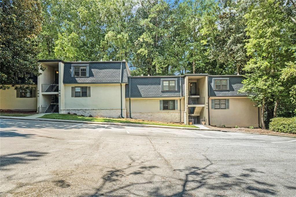 94 Rosaire Place Northwest Atlanta, GA 30327 - Photo 13 of 21 a front view of a house with a yard and garage