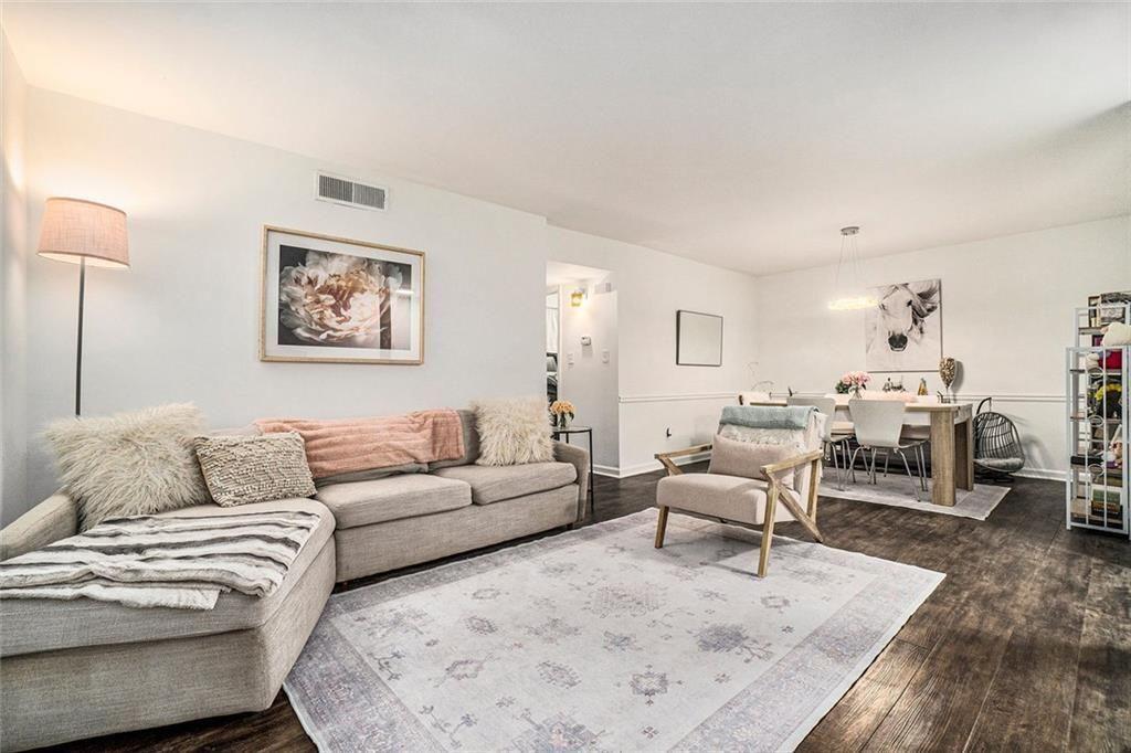 94 Rosaire Place Northwest Atlanta, GA 30327 - Photo 4 of 21 a living room with furniture and a wooden floor