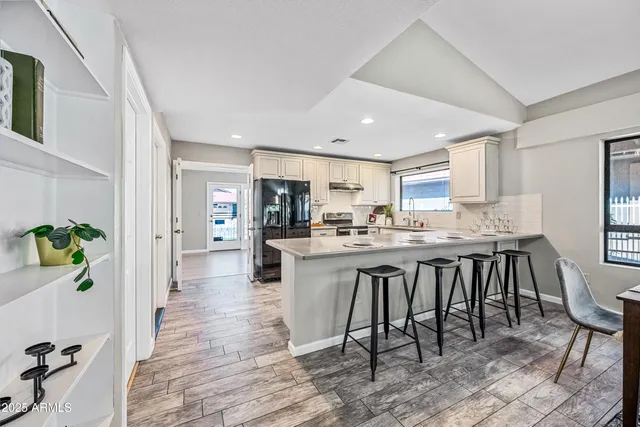 a kitchen with white cabinets and appliances