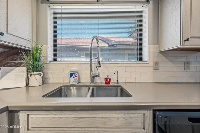 a spacious bathroom with double sink and a mirror
