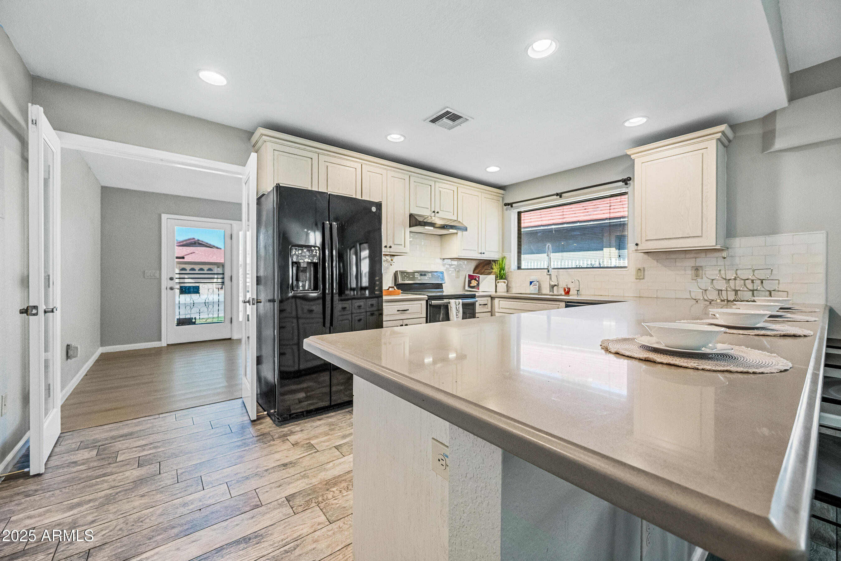 5751 West Del Rio Street Chandler, AZ 85226 - Photo 17 of 44 a kitchen with stainless steel appliances granite countertop a sink stove and refrigerator