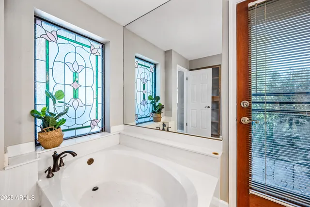 a bathroom with a granite countertop shower mirror and a sink