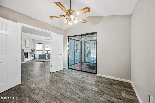 a view of an empty room with wooden floor