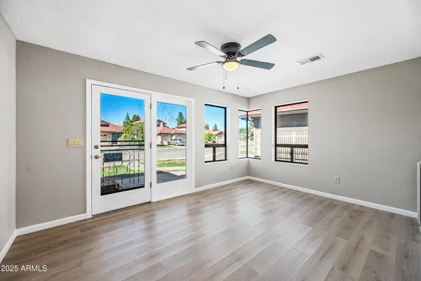 wooden floor in an empty room with a window