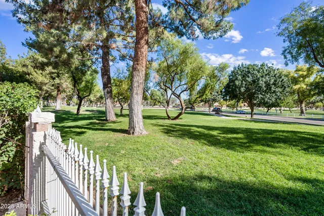 a view of a balcony with a yard