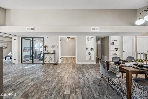 a living room with furniture and wooden floor
