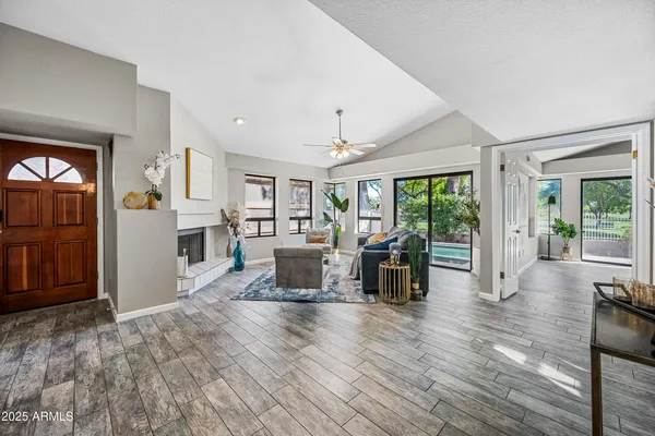 a living room with furniture and a wooden floor