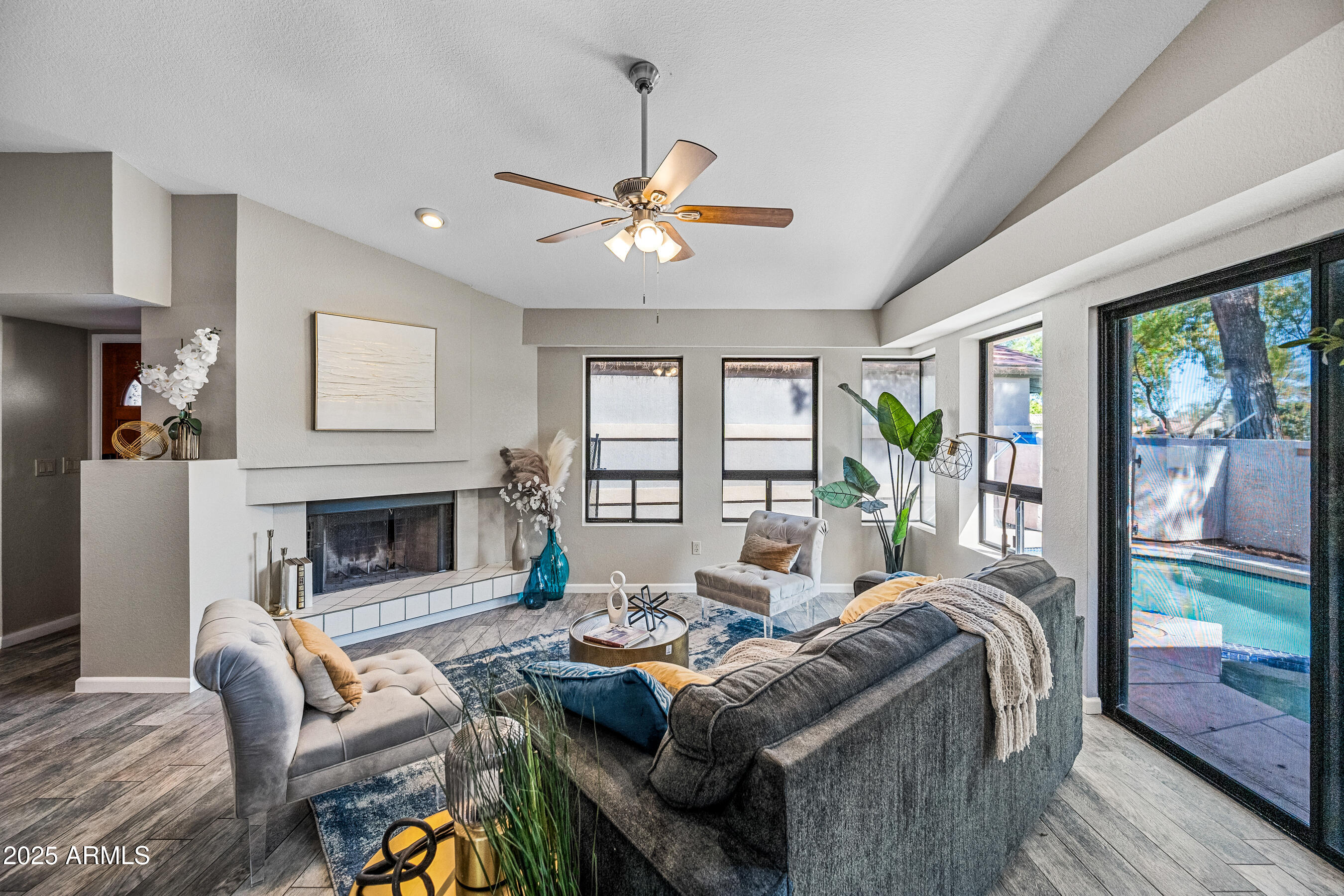5751 West Del Rio Street Chandler, AZ 85226 - Photo 8 of 44 a living room with furniture a fireplace and a large window