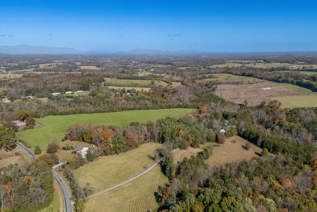 an aerial view of a houses with a yard