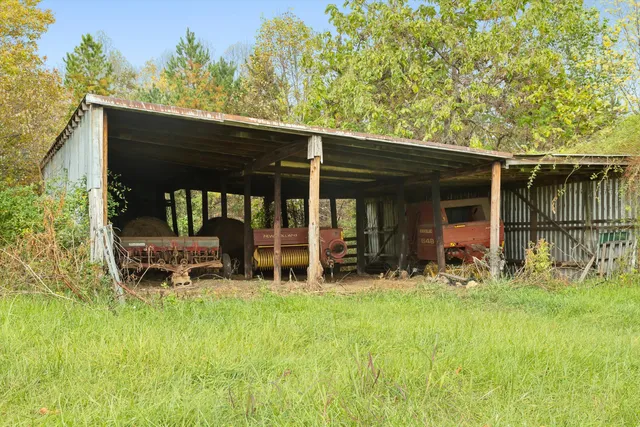 a view of a house with yard and sitting area