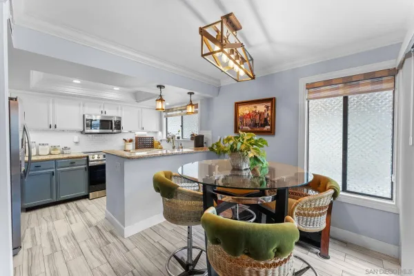 a living room with stainless steel appliances kitchen island granite countertop furniture and a kitchen view