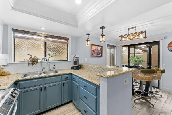 a kitchen with a sink and large window