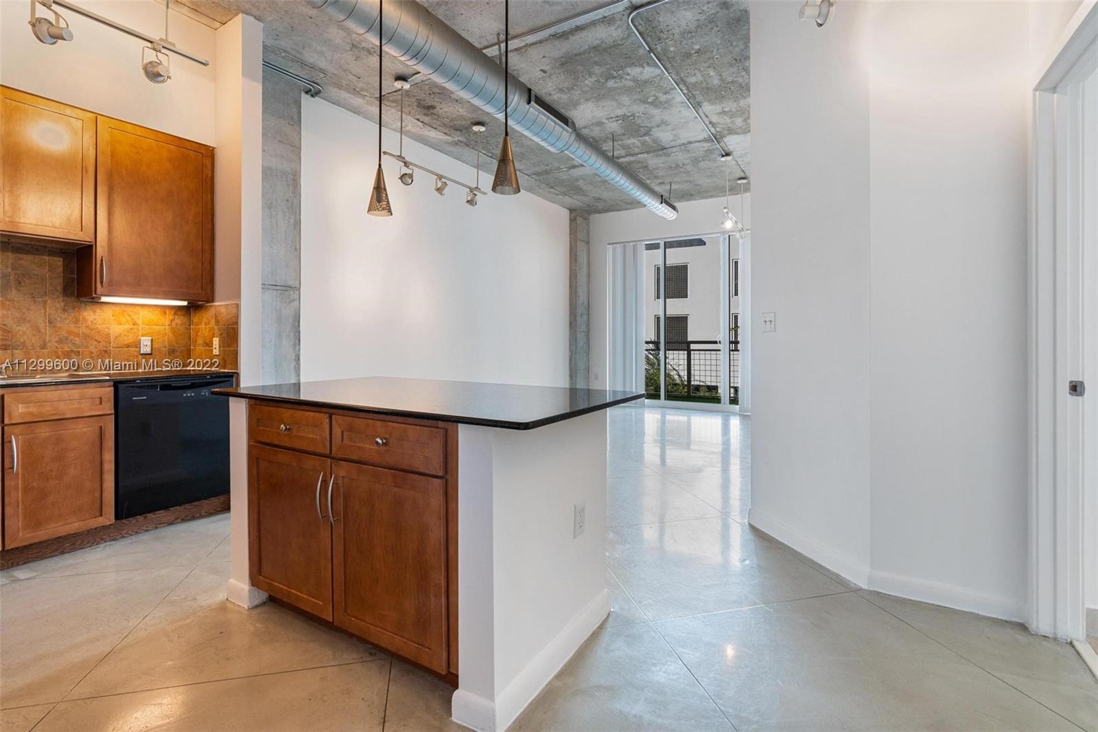 2001 Biscayne Boulevard, Unit 2308 Miami, FL 33137 - Photo 1 of 17 a kitchen with stainless steel appliances granite countertop a sink and a refrigerator