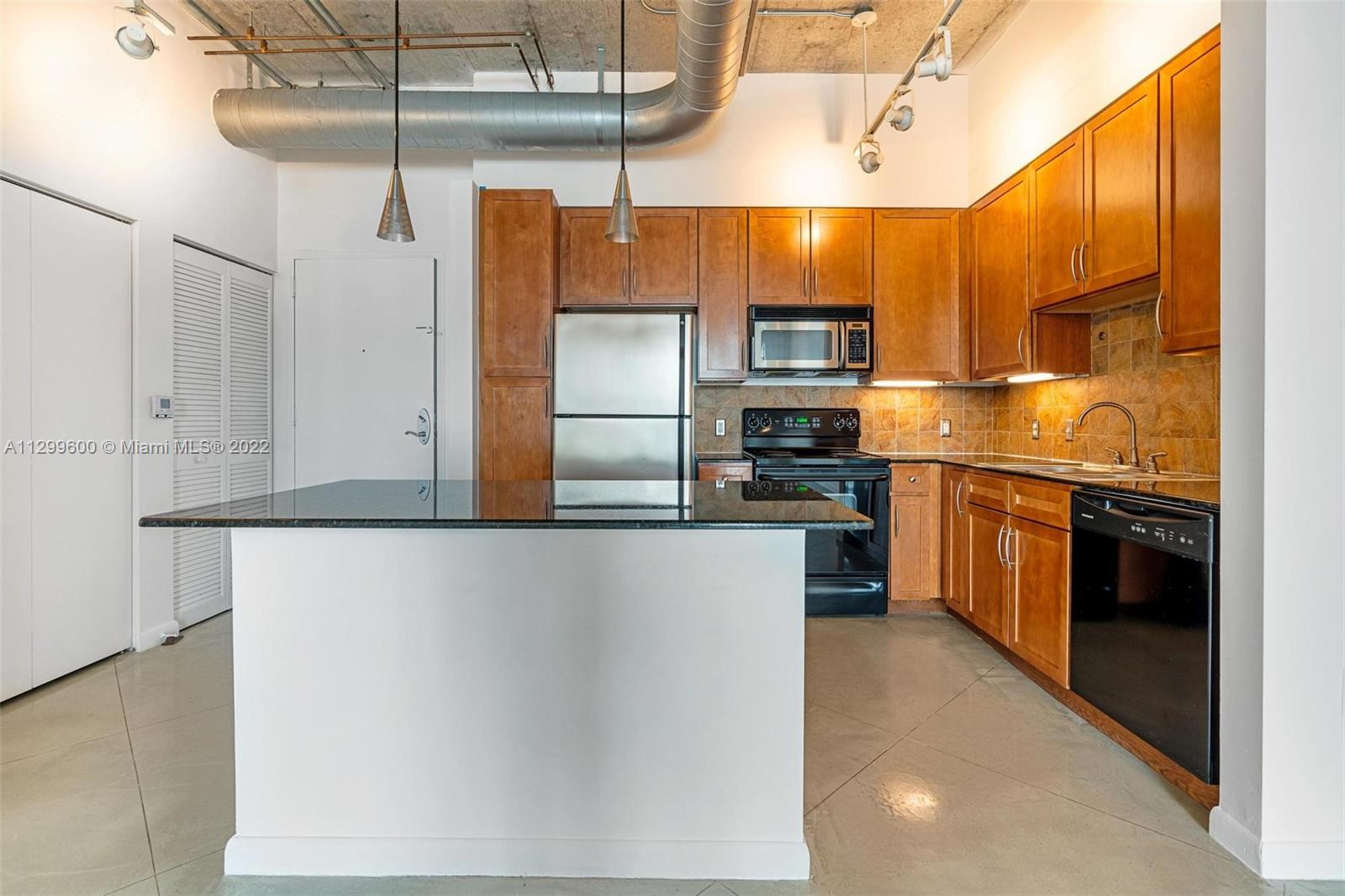 2001 Biscayne Boulevard, Unit 2308 Miami, FL 33137 - Photo 2 of 17 a kitchen with stainless steel appliances a refrigerator and a stove top oven