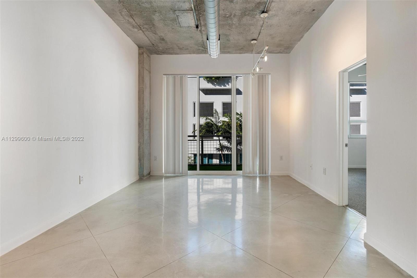 2001 Biscayne Boulevard, Unit 2308 Miami, FL 33137 - Photo 3 of 17 wooden floor in an empty room with a window
