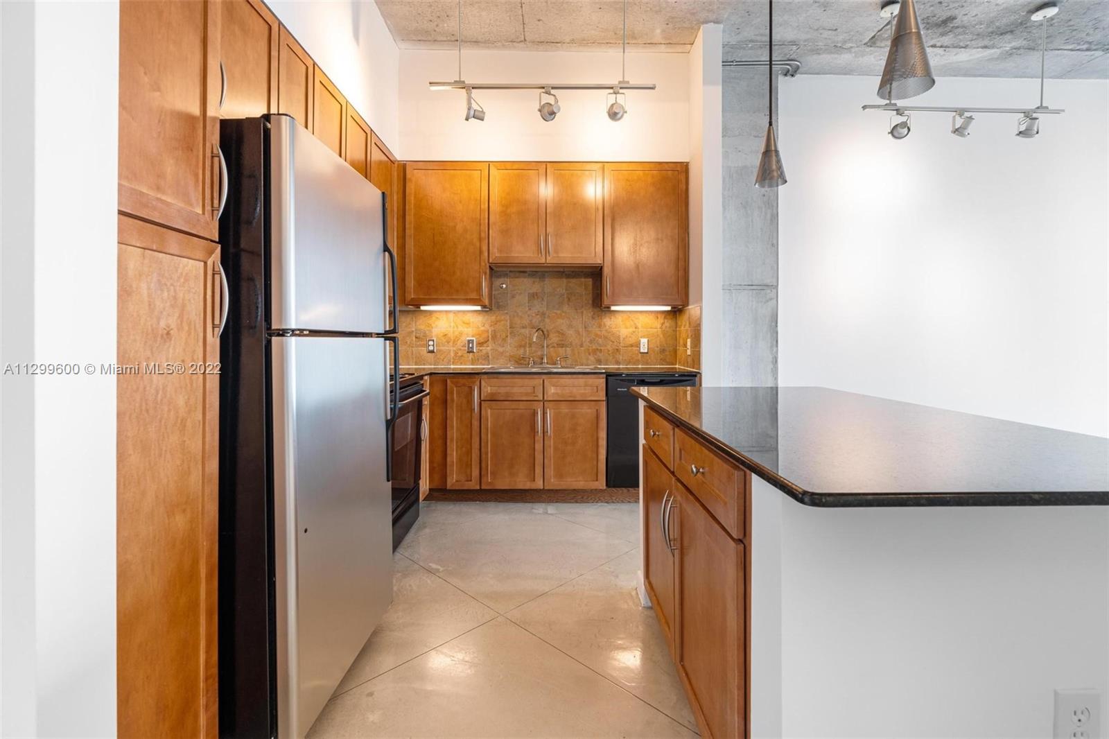 2001 Biscayne Boulevard, Unit 2308 Miami, FL 33137 - Photo 4 of 17 a kitchen with stainless steel appliances a refrigerator and a sink