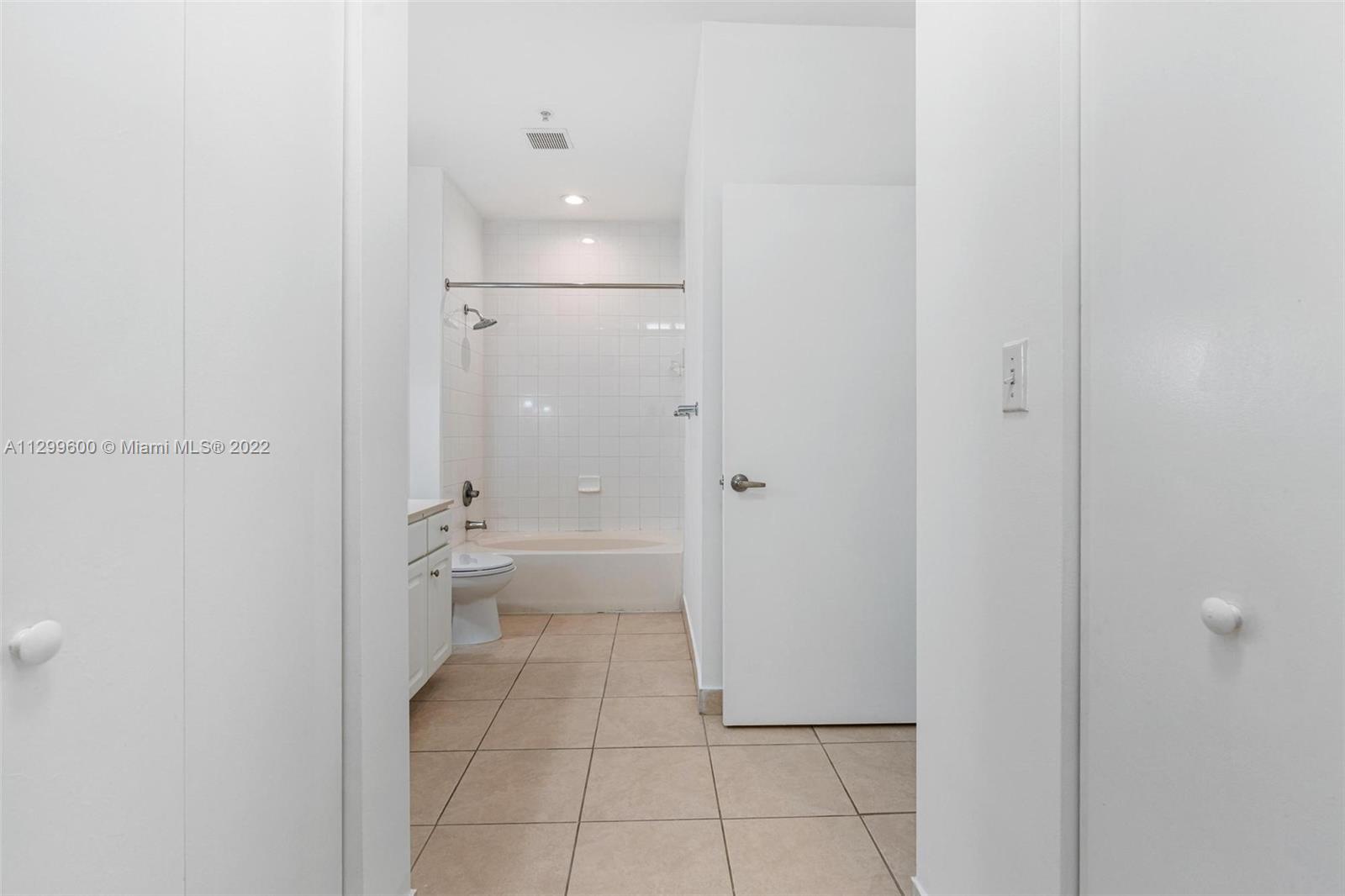 2001 Biscayne Boulevard, Unit 2308 Miami, FL 33137 - Photo 8 of 17 a bathroom with a granite countertop sink mirror and toilet