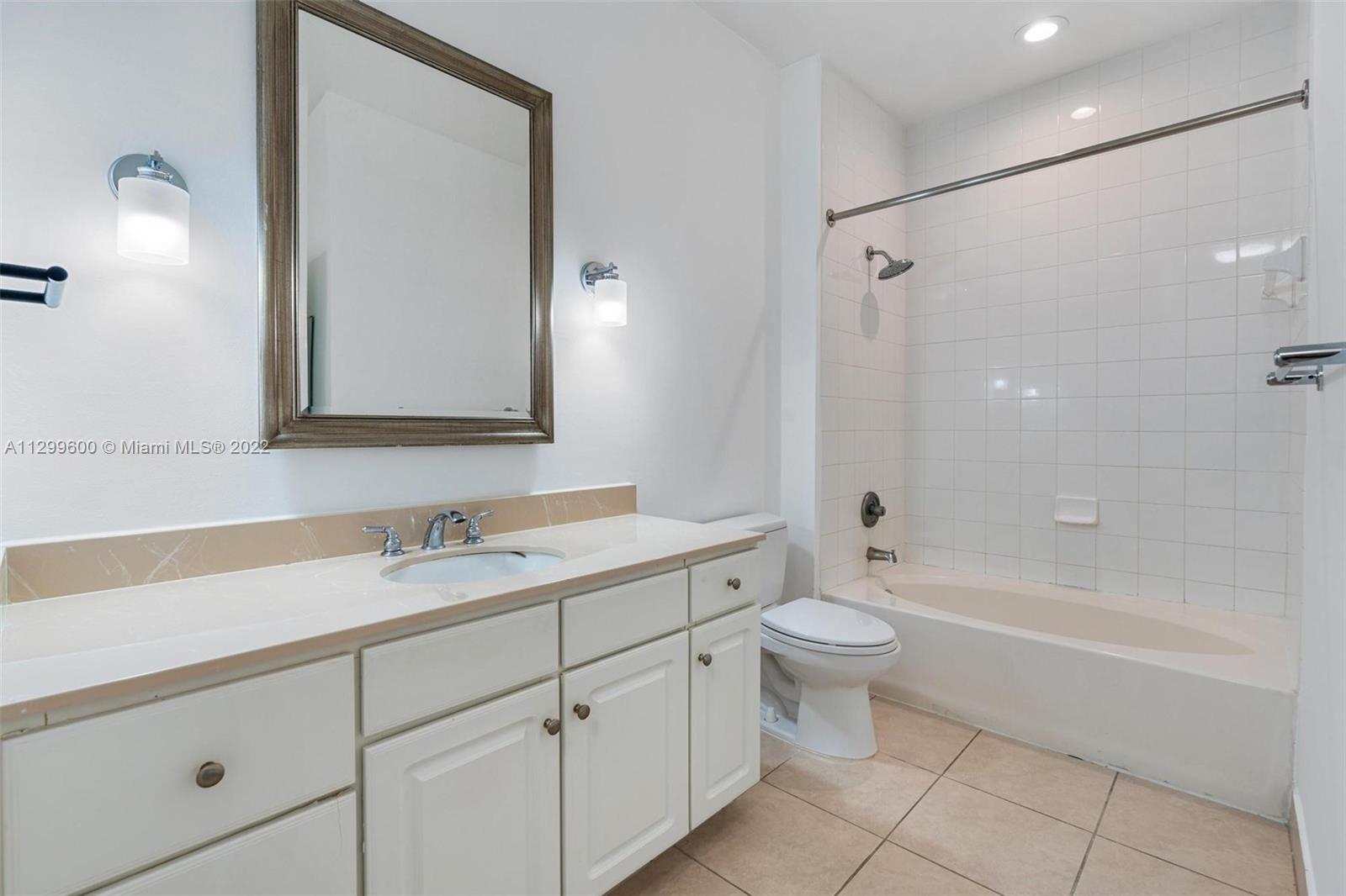 2001 Biscayne Boulevard, Unit 2308 Miami, FL 33137 - Photo 9 of 17 a bathroom with a double vanity sink toilet mirror and bathtub
