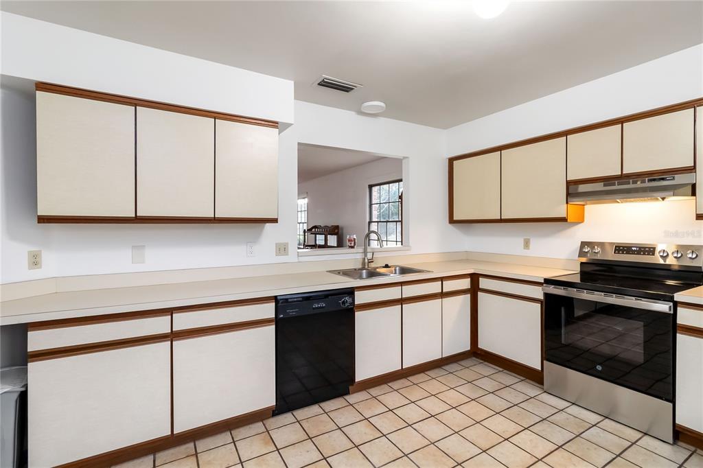 4207 Hamilton Court St. Cloud, FL 34769 - Photo 10 of 30 a kitchen with a sink cabinets and stainless steel appliances
