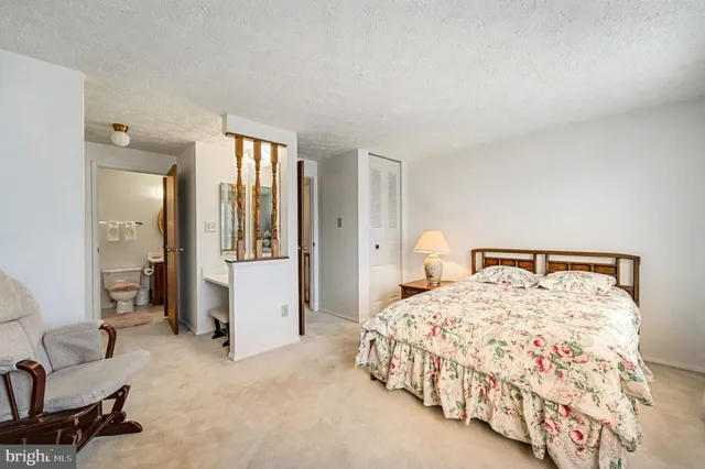 a bedroom with a bed and a couch