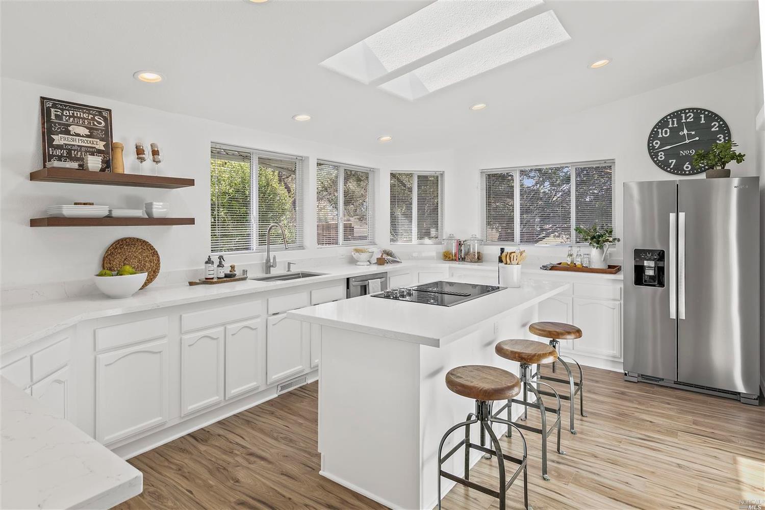 28 Yosemite Road San Rafael, CA 94903 - Photo 1 of 1 Large Chef's kitchen includes quartz countertops, island w state of the art cooktop, Wall oven-microwave combo. All the windows and skylight above the island provides plenty of light all day long. Plus the view of the open space and hills make you never want to leave this space.