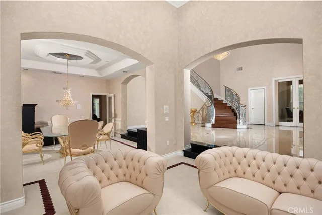 a living room with fireplace furniture and a floor to ceiling window