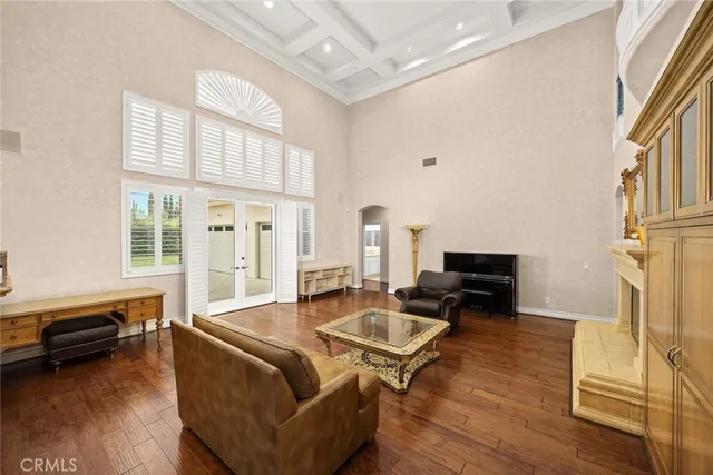 a large kitchen with kitchen island granite countertop a stove a sink dishwasher and white cabinets with wooden floor