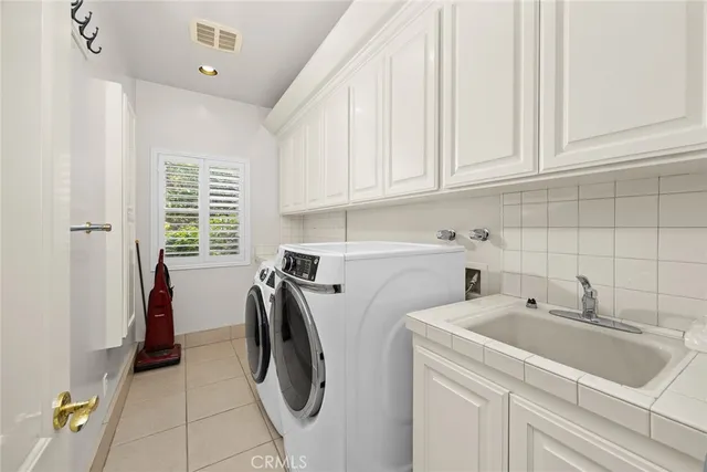 a large white bathroom with a large mirror vanity shower and bathtub