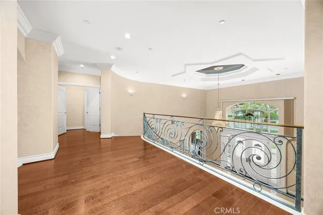 a view of balcony with a couple of cars parked in front of it