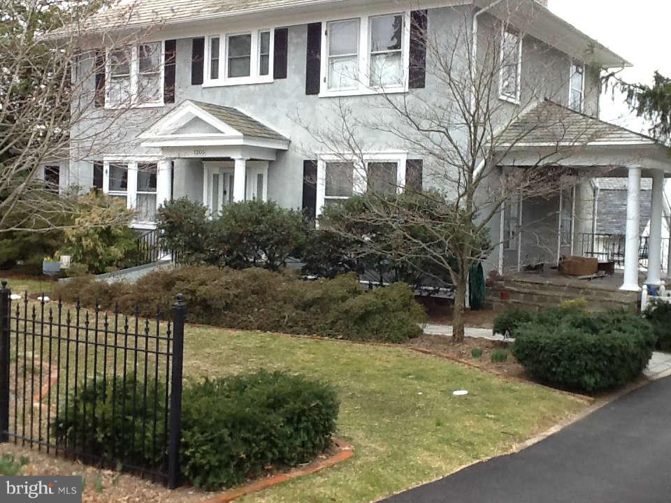 1205 Frederick Road Baltimore, MD 21228 - Photo 1 of 30 a front view of a house with a yard