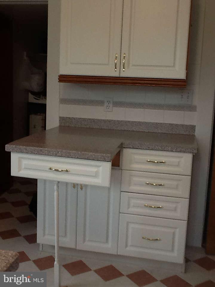 1205 Frederick Road Baltimore, MD 21228 - Photo 23 of 30 a view of white cabinets and a wooden floor