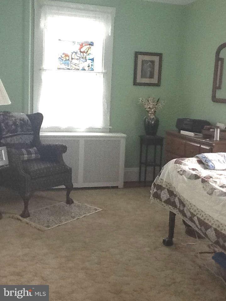 1205 Frederick Road Baltimore, MD 21228 - Photo 29 of 30 a bed sitting in a bedroom next to a window