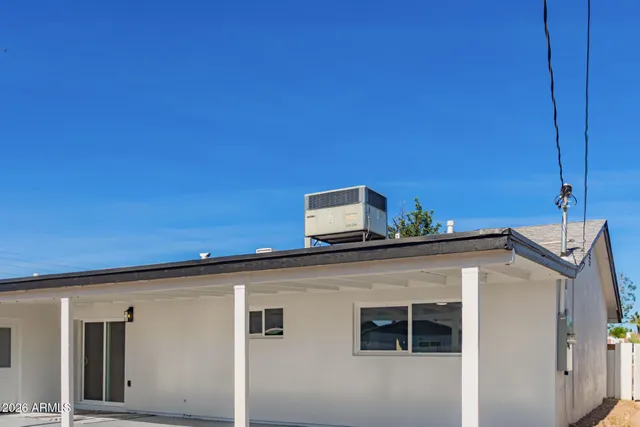 a view of a hallway with wooden floor and entryway