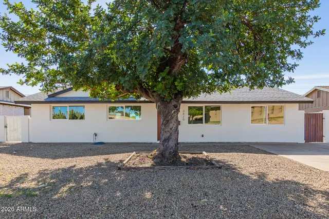 a view of a house with large tree